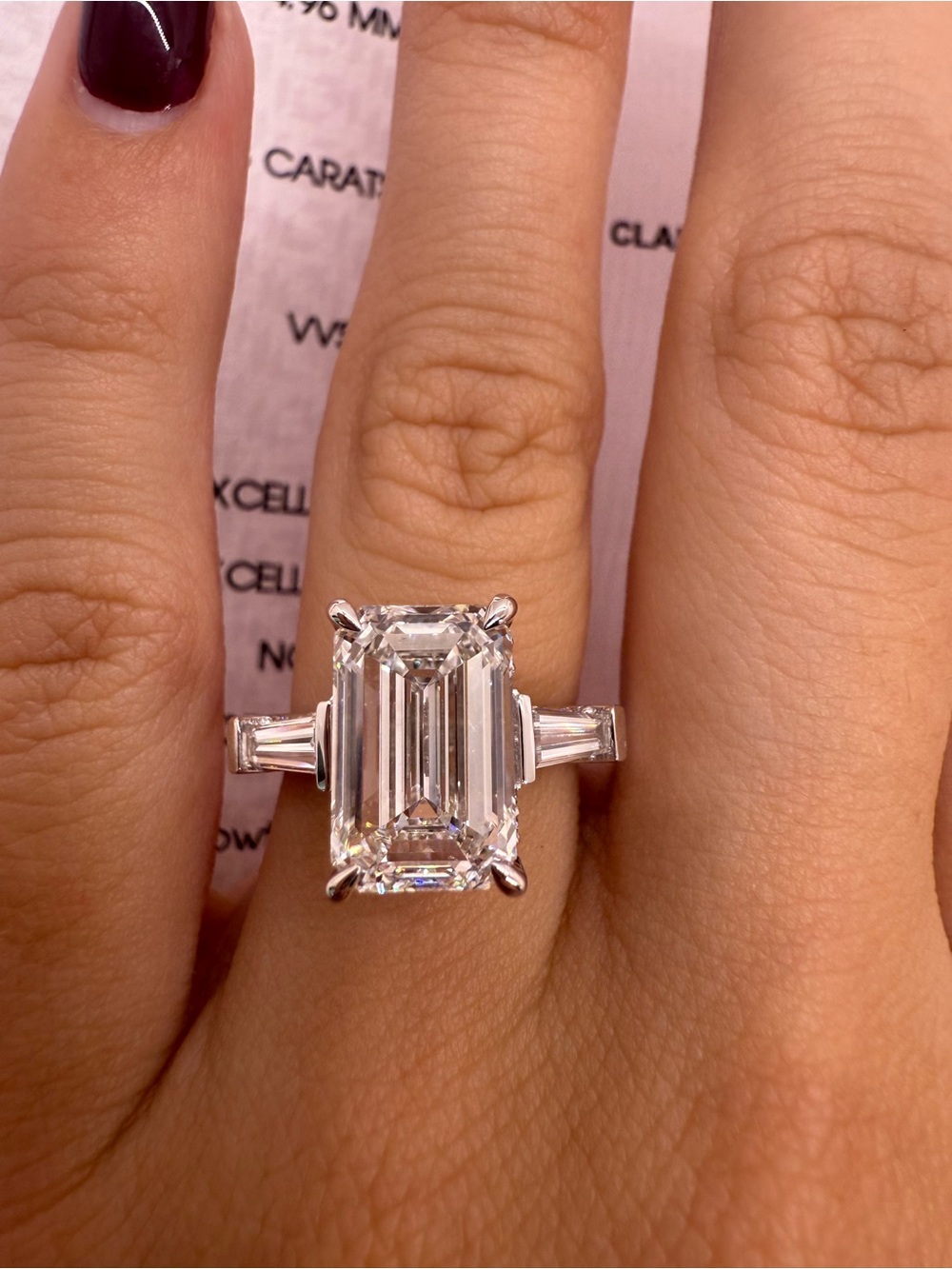 4.53 carat E VVS2 emerald cut diamond engagement ring three stone